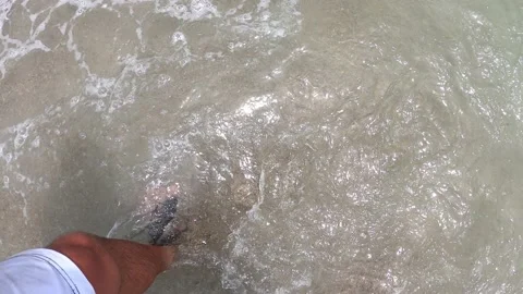 POV first person view getting out of the water on the beach and the sandals Stock Footage 195128113