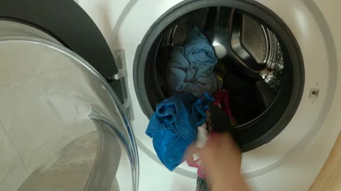 POV: First person view of loading washing machine with dirty laundry and clothes Stock Footage 154283265