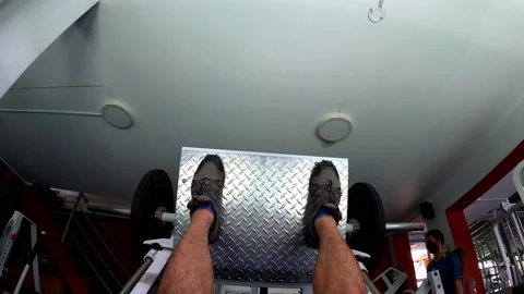 POV first person view lying on a leg press working out at the gym Video stock 164589101