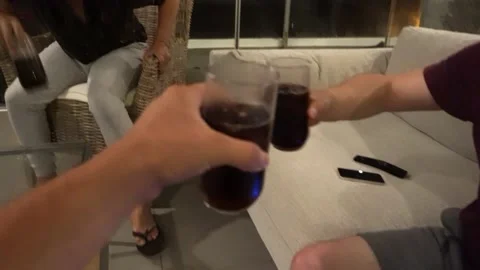 POV first person view making a toast with friends holding glass cups with black Stockbeeldmateriaal 181897404