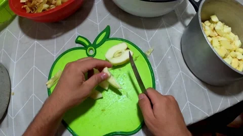 POV first person view peeling and cutting an apple on the dining table to Stock Footage