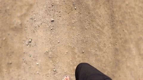 POV first person view running with sandals on his feet on dirt and stone on the Stock Footage 194444729