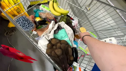 Pov first person of view take out products from trolley to cashier line Stock Footage 209928635
