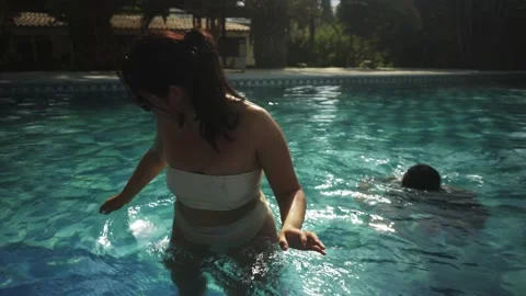POV first person view throwing beer cans at friends in the pool at a country Stock Footage 170021728