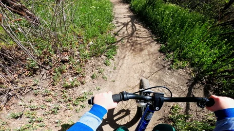 POV five year old boy rides bicycle on mountain biking path in summer Video stock 191211763