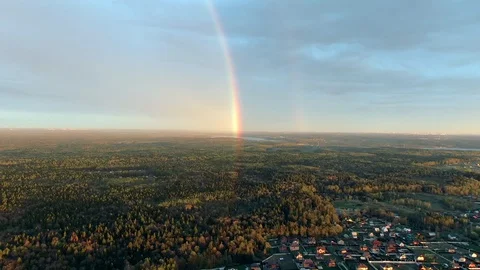 POV flight in the direction of the rainbow over the forest at sunset Video stock 130114908