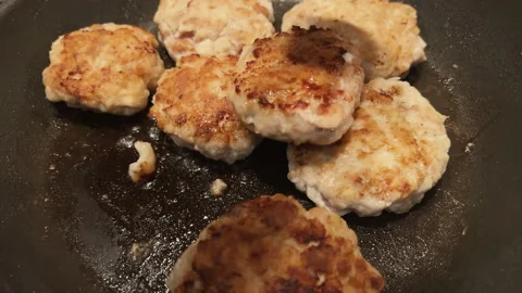 POV flip over fried cutlets on frying pan. Moving patty cakes. Cooking at home Stock Footage 272996962