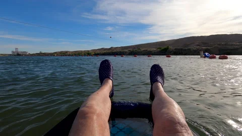 POV-Floating River view of legs and feet Stock Footage 136002870
