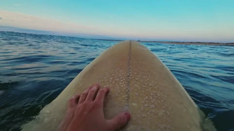 POV floating on surfboard in Atlantic Ocean at sunset Stockbeeldmateriaal 339450596