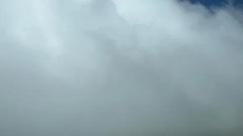 POV flying across some tiny white clouds. Pilot perspective shot from a Stock Footage 273660847