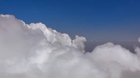 POV Flying in a Left Turn Through Cottony Cumulus Clouds Bathed in Sunset Light Stock Footage 345365804