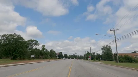 POV FPV driving cloudy sky urban scene people vintage retail storefronts and  Stock Footage 204947997