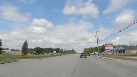 POV FPV driving cloudy sky urban scene retail stores Family Dollar traffic To Stock Footage 204948039