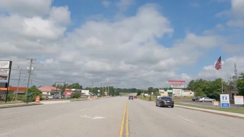 POV FPV driving cloudy sky urban scene retail stores vintage stores traffic o Stock Footage 204948246