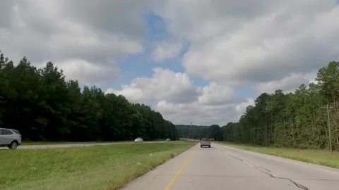 POV FPV driving cloudy sky two lanes become one construction zone Hwy 1 Stock Footage 204949023