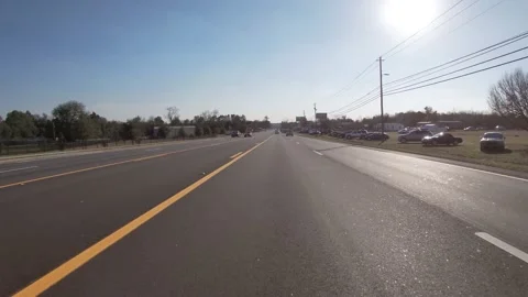 POV FPV driving down a newly paved highway with the sun beaming and traffic Stock Footage 149280474