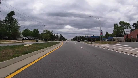 POV FPV driving on a newly designed road passing a gas station gas price 2.65 Stock Footage 156221757