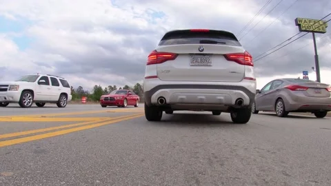 POV FPV low to the ground Busy traffic a BMW and time lapse traffic Stock Footage 148251137