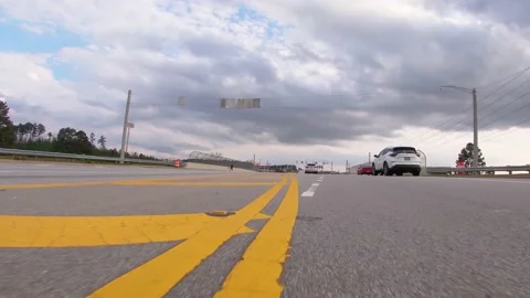 POV FPV low to the ground Busy traffic at a bridge cross intersection and mer Stock Footage 148251624
