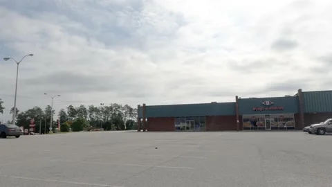 POV FPV pan old retro vintage retail shopping center Wings restaurant Stock Footage 204949226