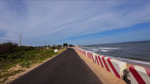 POV front vehicle view driving on empty seaside road with median strip Stock Footage 341758596