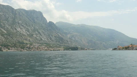 POV. Front view of a boat moving forward on the sea bay. Kotor bay Montenegro Stock Footage 104597985