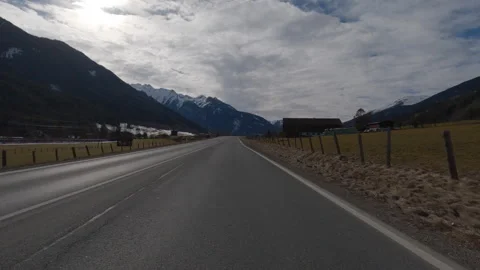 POV FRONT VIEW DRIVING PLATE car driving on winter roads in Austrian Alps Stock Footage 255202359