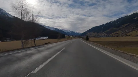 POV FRONT VIEW DRIVING PLATE car driving on winter roads in Austrian Alps Stock Footage 255202523
