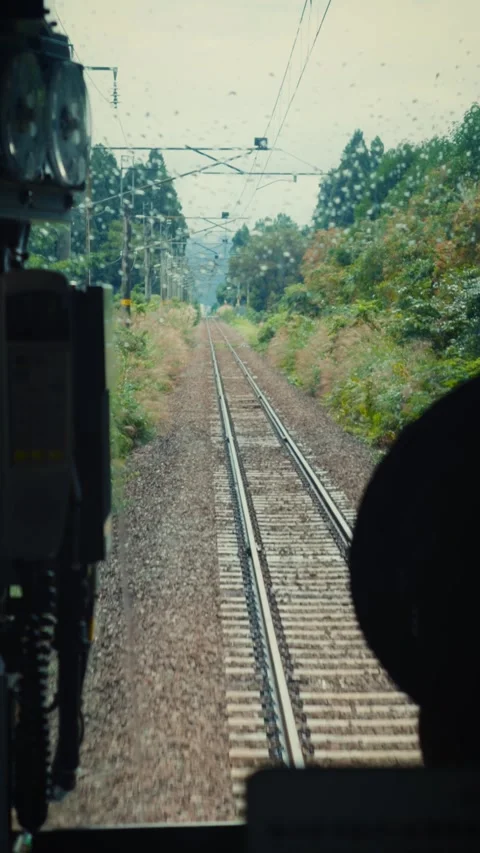 POV front view from moving train in rainy Japanese countryside Stock Footage 346203976