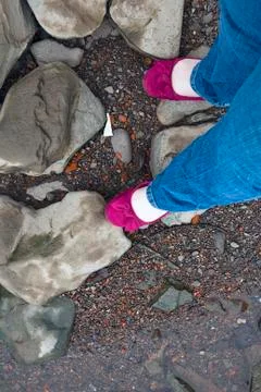POV girlie feet at the edge of a stream Stock Photos