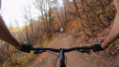 POV  Go Pro of a mountain biker following another, Park City, UT. Video stock 99519787