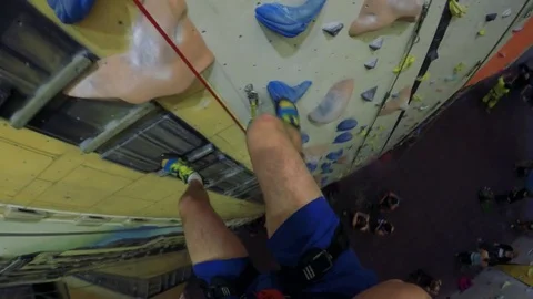 POV GoPro - a man ropes down on a colorful training wall Stock Footage 79540293