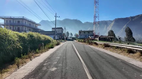 POV Ground Level Road Through Mountain Village Sunrise Stock Footage 345152359
