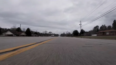 POV Ground view driving through a country rural residential area Stock Footage 196640181