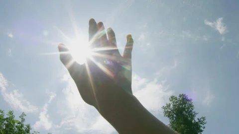 Pov of an hand covering the sun Stock Footage 314858375