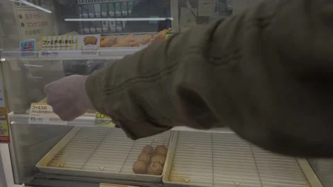 POV hand selects convenient store snacks from display case Stock-Footage 228756715