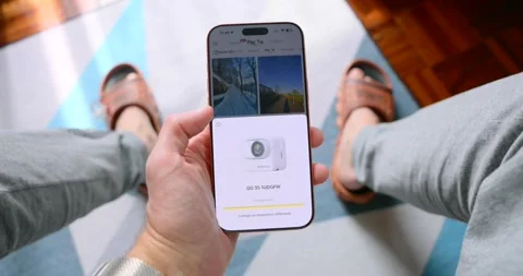 POV of Hand Using Smartphone App to Control Action Camera 库存影片 348775135