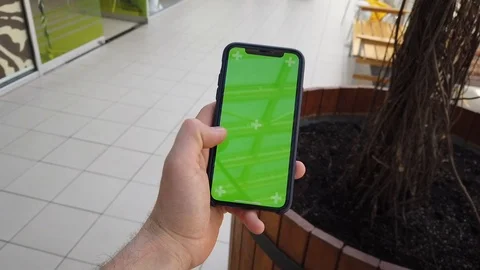 POV, hand using smartphone with green screen in the shopping mall Stock Footage 115637742