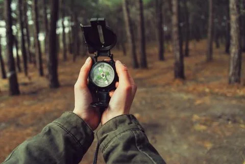 POV of hands with a compass Stock Photos