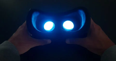 POV. Hands holds Virtual Reality Headset.Neon light inside Stock Footage 220732035
