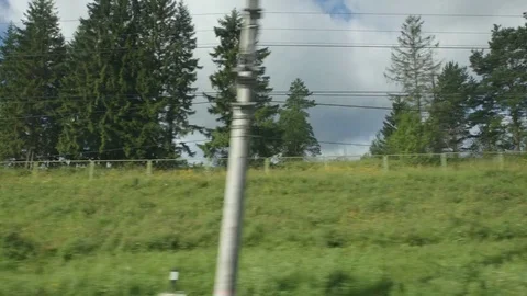 POV: High-speed Train fast moves past a trees on a hill - bottom view Stock Footage 80460805