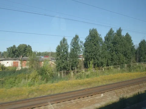 POV: High-speed Train moves past a suburb of a town in the summer Stock Footage 80460561