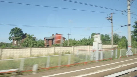 POV: High-speed Train moves past a small station in the summer Stock Footage 80460661
