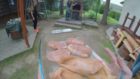 POV of host bringing raw meat preparing grill for barbecue party with cheerfu Video stock 86216913