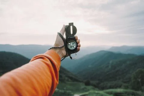 POV image with compass in mountains Stock Photos