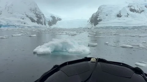 POV from Inflatable Boat Approaching Antarctic Glacier Through Floating Ice Stock Footage 339223103