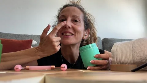 POV influencer applying face cream for social media Stock Footage 342498486