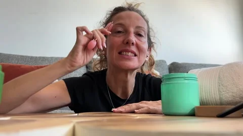 POV influencer using facial roller for social media Stock Footage 342498355