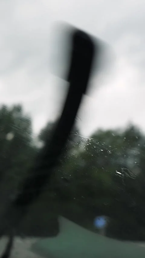 POV from inside a car onto raindrops on the windshield 動画素材 332350714