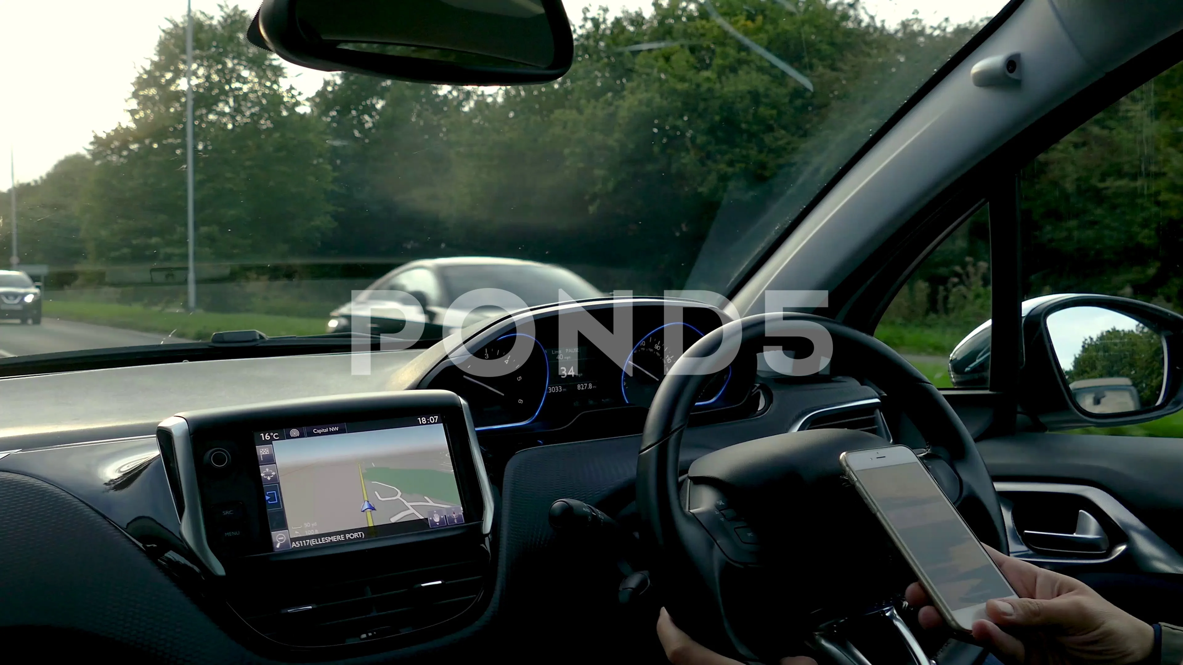 Pov inside a modern SUV car where driver is texting and driving. Dangerous